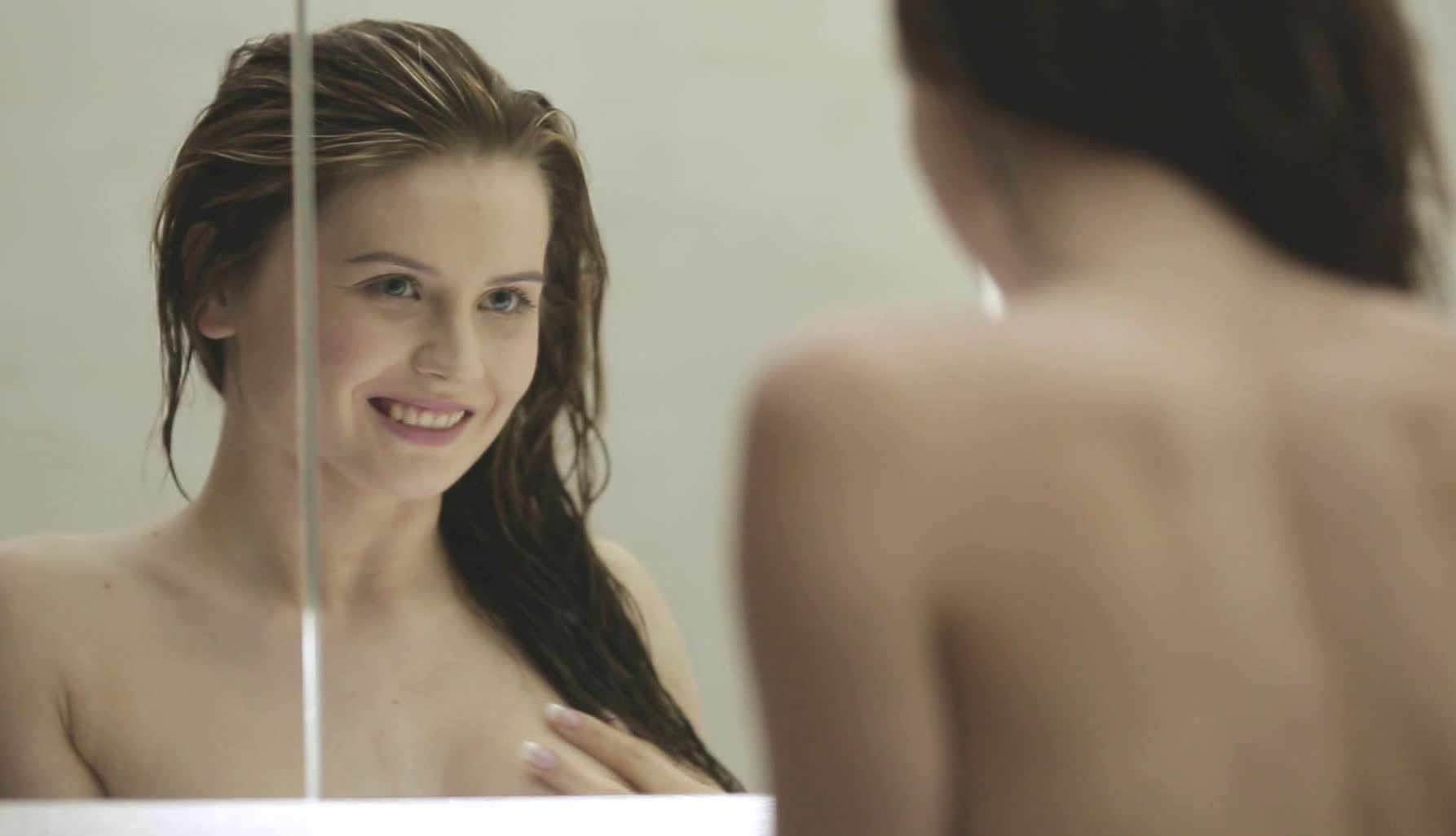 smiling babe masturbates in the bathroom in solo video